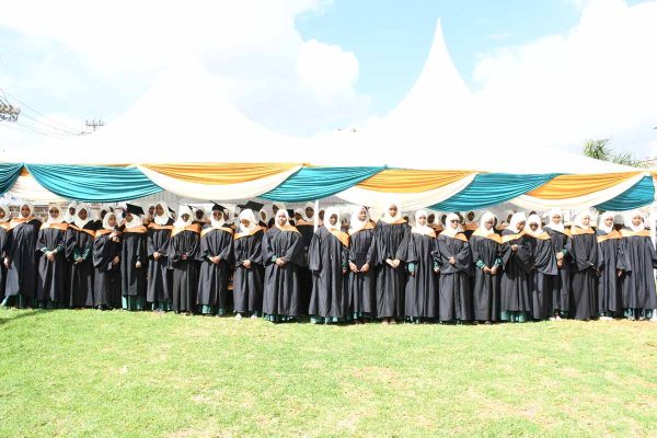 graduands passionately singing the school anthem